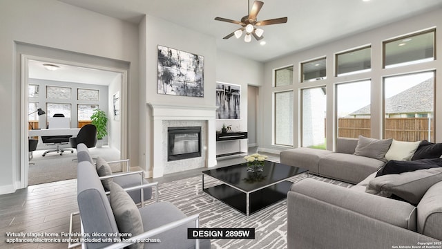 2940 Harvest Moon, Seguin, TX 78155 - living room featuring a ceiling fan, wood finished floors, baseboards, a glass covered fireplace, and recessed lighting