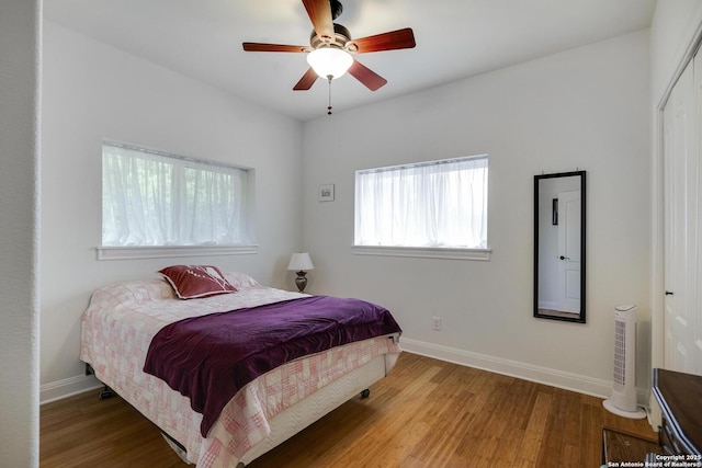 16812 Fox Rdg, Helotes, TX 78023 - bedroom with a closet, baseboards, a ceiling fan, and wood finished floors