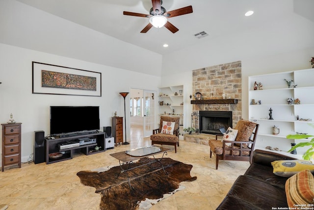 16812 Fox Rdg, Helotes, TX 78023 - living room featuring ceiling fan, a stone fireplace, built in features, vaulted ceiling, and visible vents
