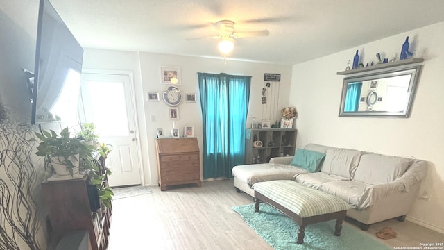 sitting room with a ceiling fan and wood finished floors
