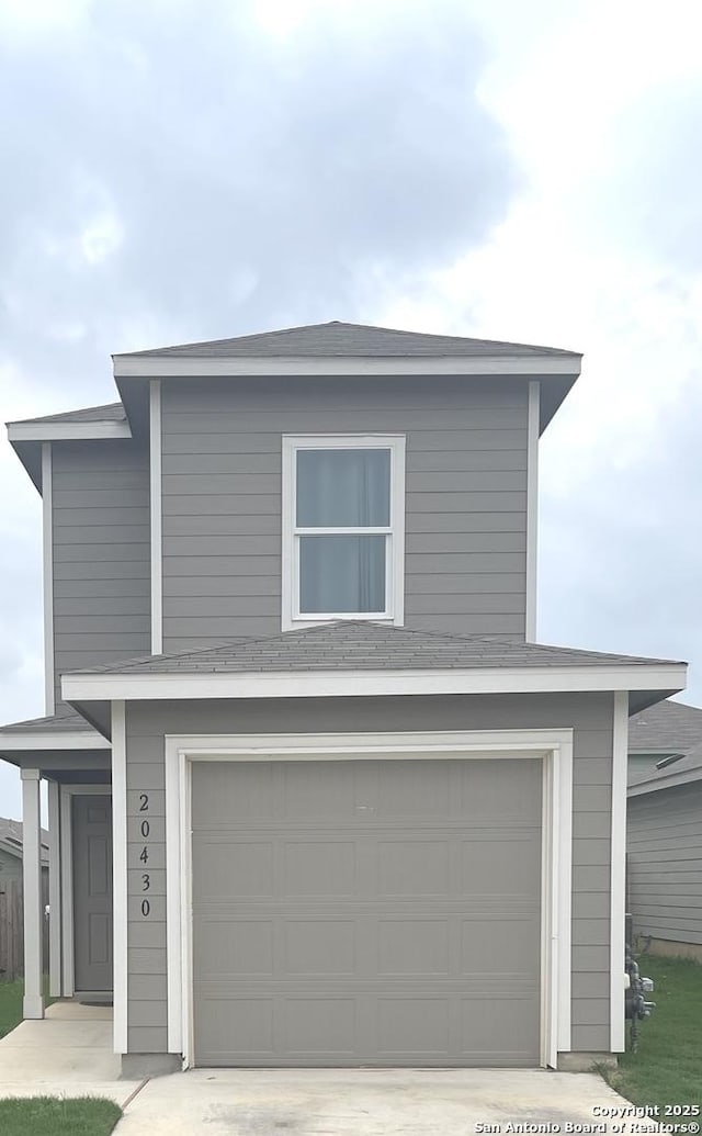 traditional home with driveway and a garage