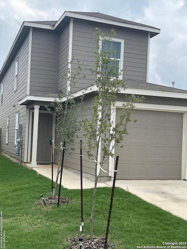 traditional home with a front lawn and concrete driveway