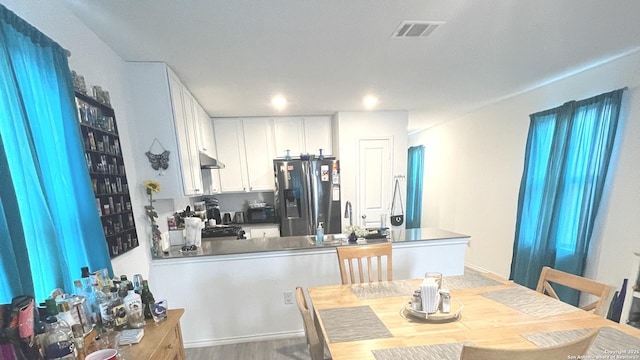 dining space featuring wood finished floors and visible vents