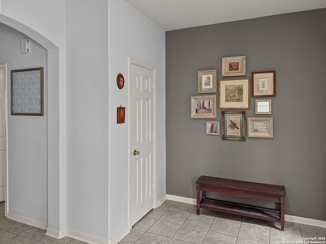 51 Roan, San Antonio, TX 78259 - hallway with arched walkways, baseboards, and light tile patterned flooring