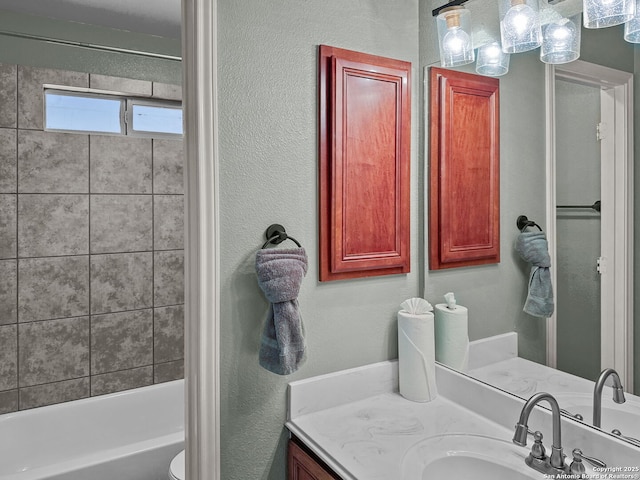 51 Roan, San Antonio, TX 78259 - full bath with vanity, a textured wall, bathtub / shower combination, and toilet