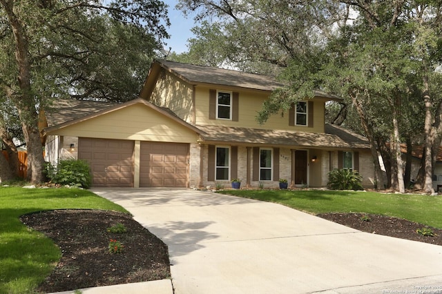 traditional-style house with a garage, roof with shingles, driveway, and a front lawn