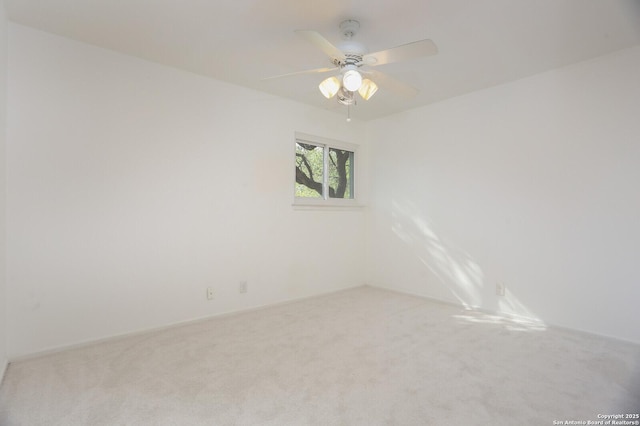 empty room with ceiling fan and light carpet