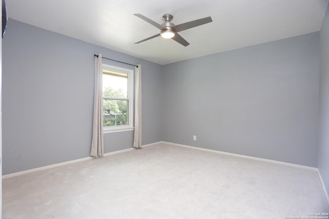 carpeted empty room with baseboards and a ceiling fan