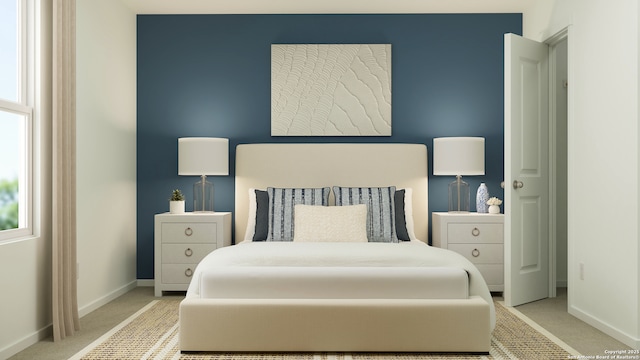 bedroom featuring light colored carpet and baseboards