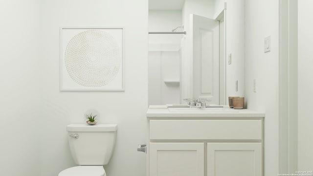 bathroom featuring toilet and vanity