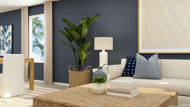 living area with baseboards and plenty of natural light