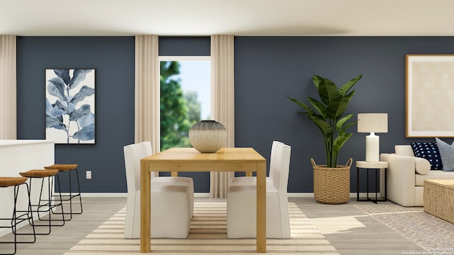 dining area featuring baseboards and wood finished floors