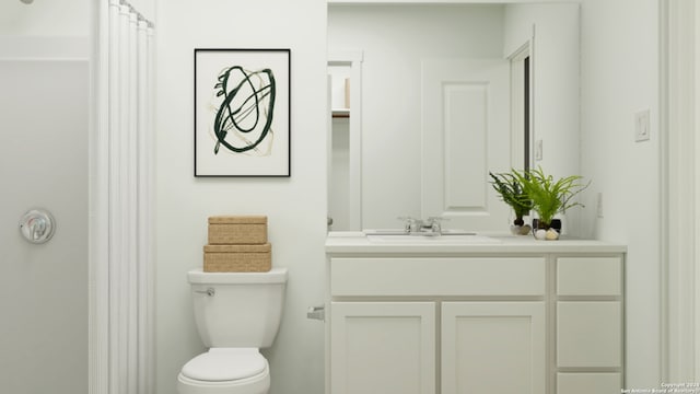 bathroom featuring vanity, curtained shower, and toilet