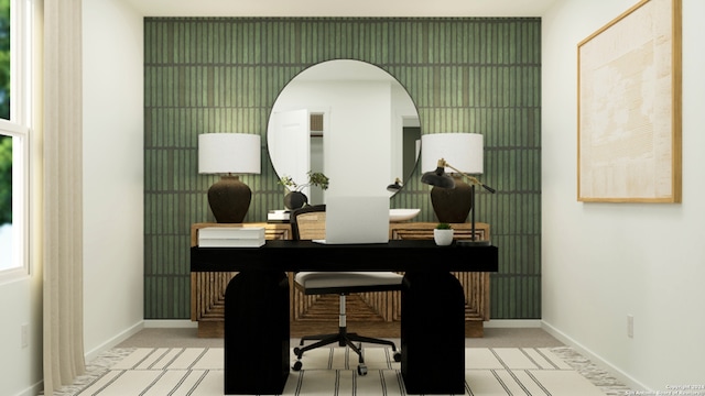office area with baseboards, light carpet, and arched walkways