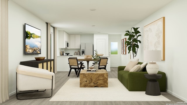 living area with baseboards and light wood-style flooring