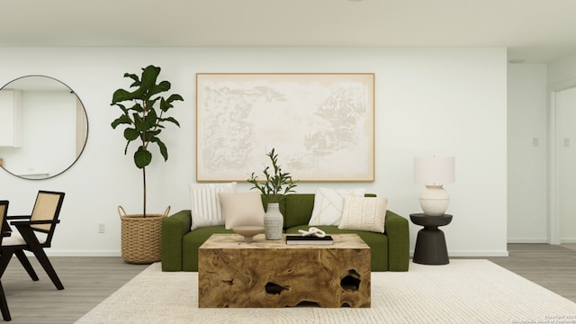living area with baseboards and wood finished floors