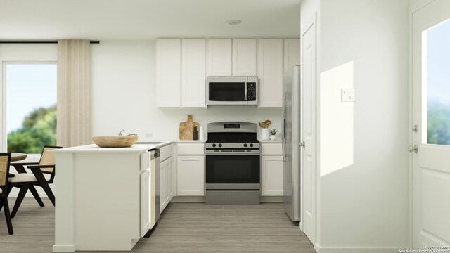 13510 Furyk Dr, San Antonio, TX 78221 - kitchen featuring a peninsula, light countertops, white cabinets, light wood finished floors, and stainless steel appliances