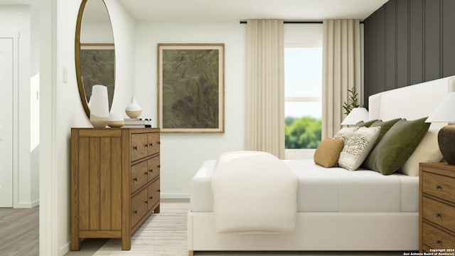 bedroom with baseboards and light wood finished floors