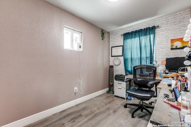 office area featuring baseboards and wood finished floors