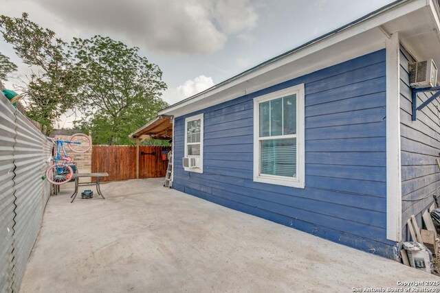 113 Chico Aly, San Antonio, TX 78225 - view of side of property featuring fence, a patio, and cooling unit