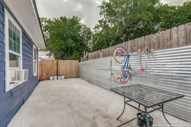 view of patio / terrace featuring fence and cooling unit