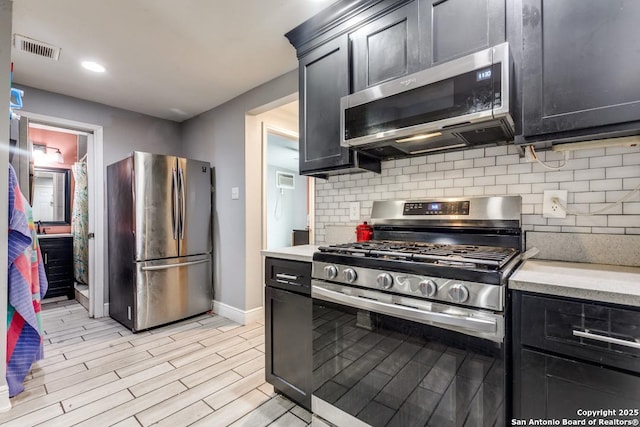kitchen featuring light countertops, stainless steel appliances, baseboards, and visible vents