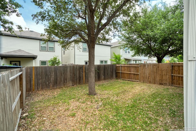 view of yard with a fenced backyard
