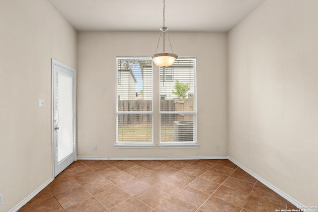 unfurnished dining area featuring tile patterned floors and baseboards