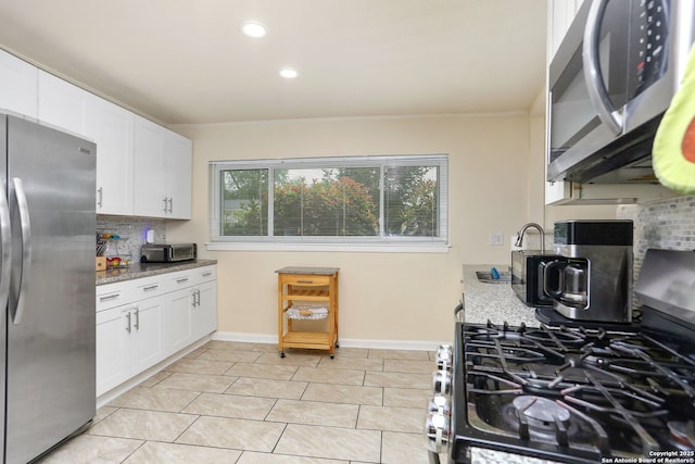202 Beverly Dr, San Antonio, TX 78228 - kitchen with appliances with stainless steel finishes, tasteful backsplash, recessed lighting, and white cabinets