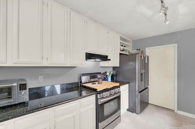 8034 Deadwood Rdg, Converse, TX 78109 - kitchen featuring rail lighting, white cabinetry, under cabinet range hood, and stainless steel appliances