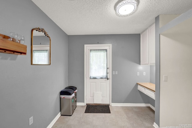 8034 Deadwood Rdg, Converse, TX 78109 - doorway to outside with baseboards, a textured ceiling, and a wealth of natural light