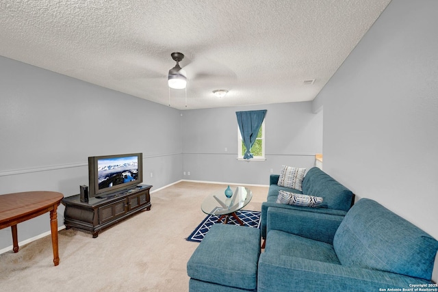 carpeted living area with a ceiling fan, baseboards, visible vents, and a textured ceiling