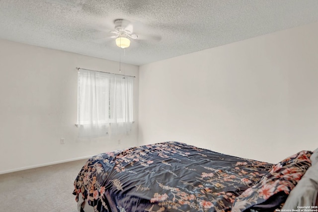 bedroom with carpet floors, baseboards, a ceiling fan, and a textured ceiling