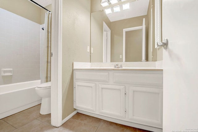 full bathroom featuring tile patterned flooring, vanity, toilet, baseboards, and shower / tub combo