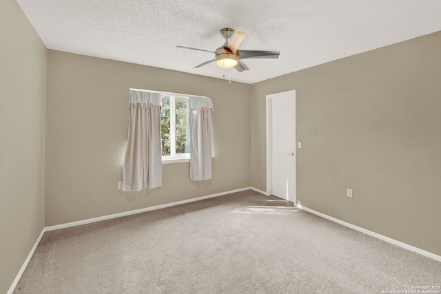 unfurnished room featuring carpet floors, a textured ceiling, ceiling fan, and baseboards