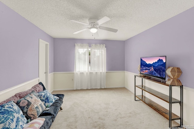 unfurnished room featuring carpet floors, ceiling fan, and a textured ceiling