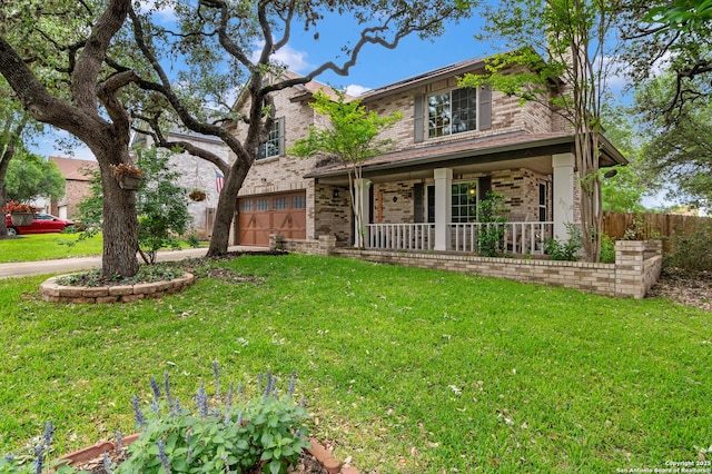 traditional-style house with covered porch, brick siding, an attached garage, and a front lawn