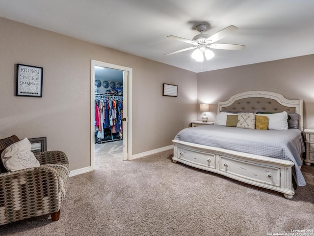 bedroom with ceiling fan, carpet, baseboards, a spacious closet, and a closet