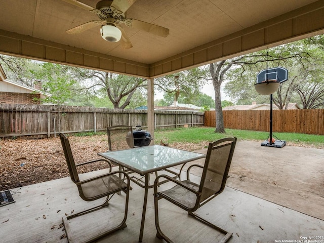 view of patio featuring a ceiling fan, outdoor dining area, and a fenced backyard
