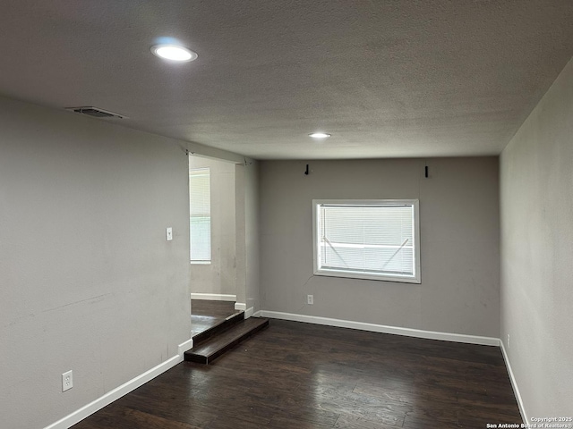 unfurnished room featuring baseboards, recessed lighting, wood finished floors, and visible vents
