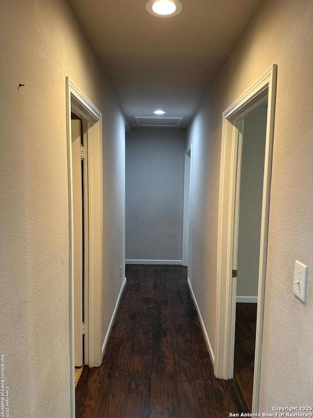 corridor with baseboards, attic access, wood finished floors, and recessed lighting
