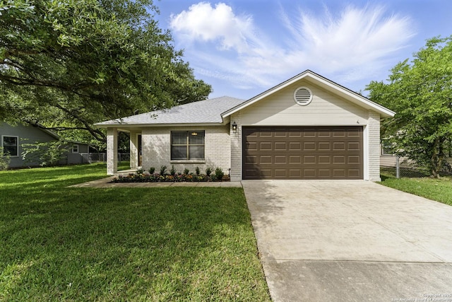 single story home featuring fence, a front yard, brick siding, an attached garage, and driveway