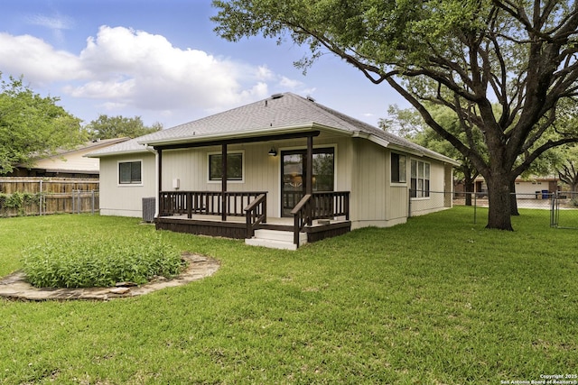 rear view of property with a lawn, a fenced backyard, central AC, and covered porch