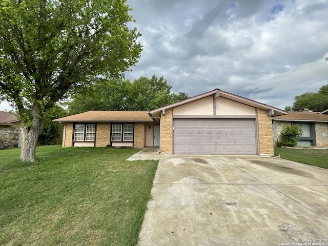 single story home featuring brick siding, a garage, a front yard, and concrete driveway