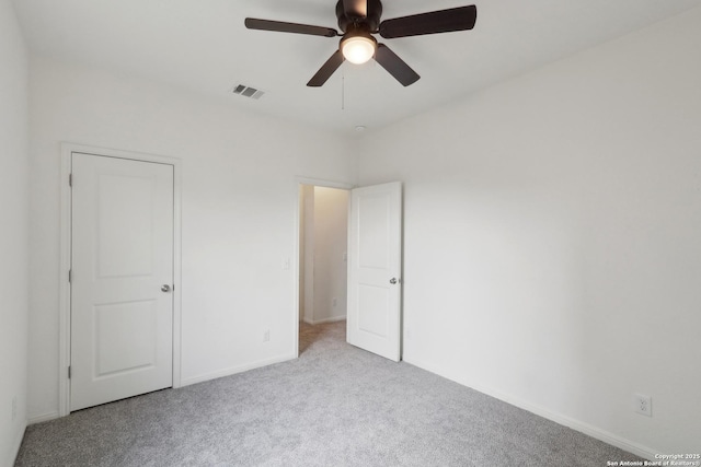 unfurnished bedroom featuring a ceiling fan, baseboards, visible vents, and carpet