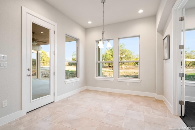 unfurnished dining area featuring recessed lighting, baseboards, and marble finish floor