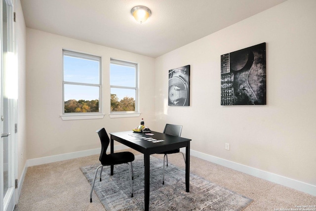 carpeted office space featuring baseboards