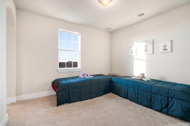 unfurnished bedroom featuring visible vents, carpet, and baseboards