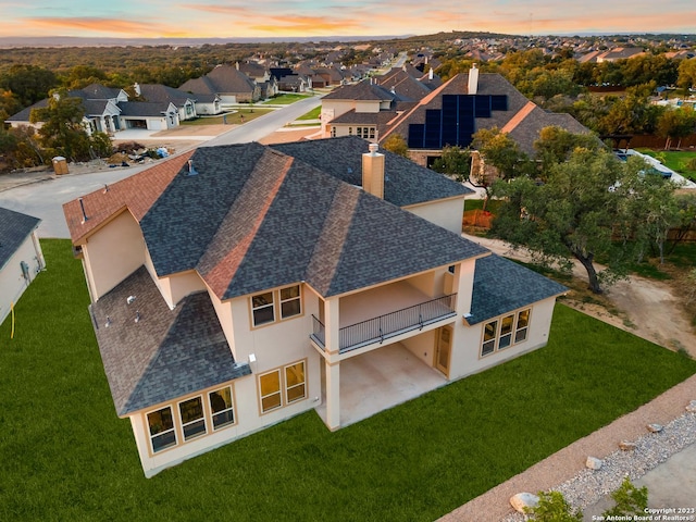 aerial view at dusk featuring a residential view