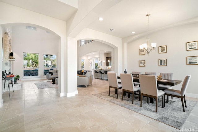 dining space with arched walkways, a chandelier, recessed lighting, baseboards, and visible vents
